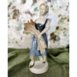 Figur von Mädchen, das mit Garbe geht