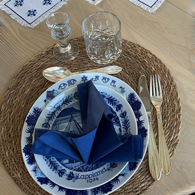 Eine charmante Weihnachtstafel in Blau und Weiß, kombiniert mit goldenem Besteck und einer blauen Serviette.
